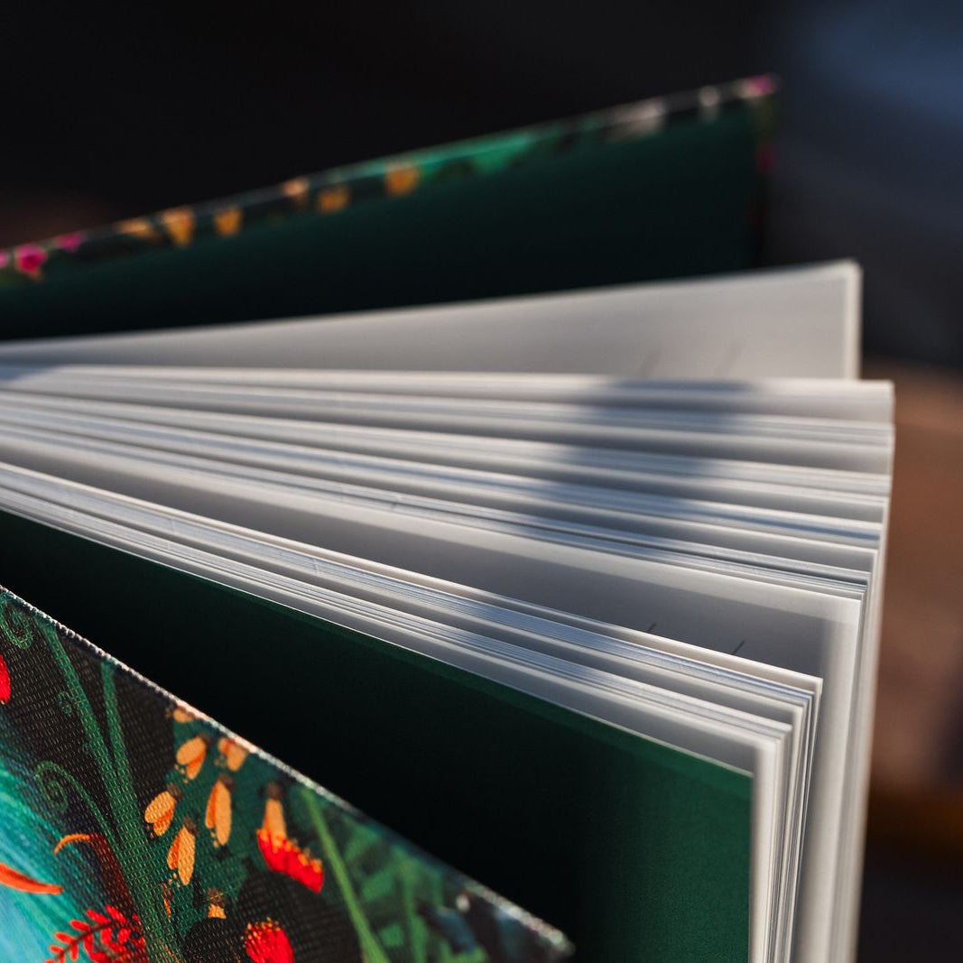 Open notebook with colorful floral design on a dark background