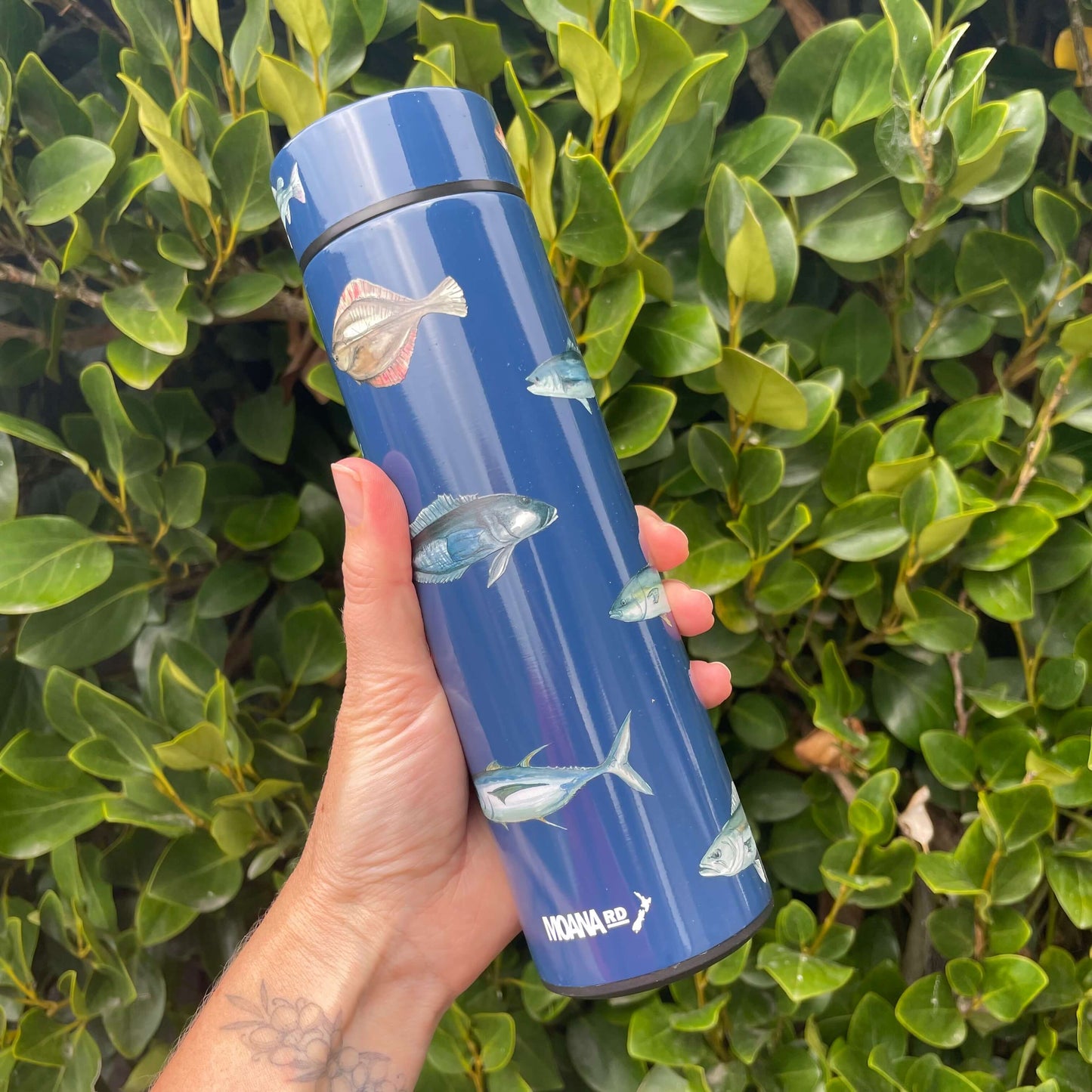 Navy blue stainless drink bottle with fish decals.