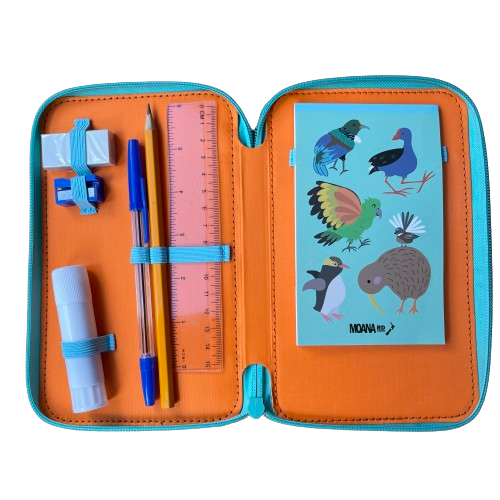 Inside of a kids mini art set featuring a notebook, pencil, pen, eraser, sharpener, gluestick and ruler.