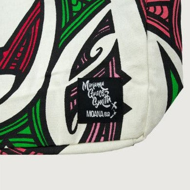 Tote bag with red, pink, green, yellow, white & black maori design.
