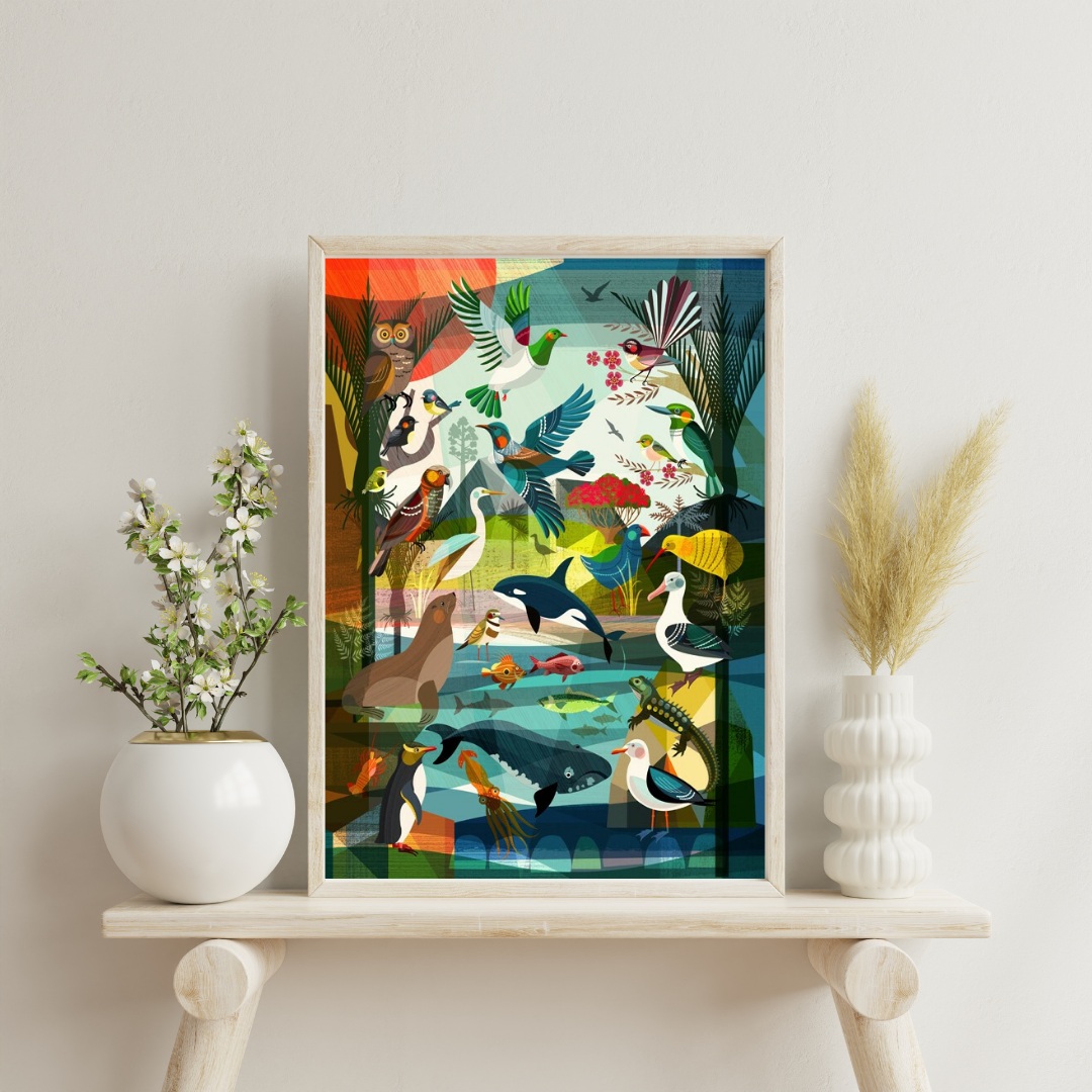 Colourful artwork by Ellen Gigenbach featuring animals of New Zealand from sea to sky. In a light coloured wooden frame on a side table with a white vase either side.