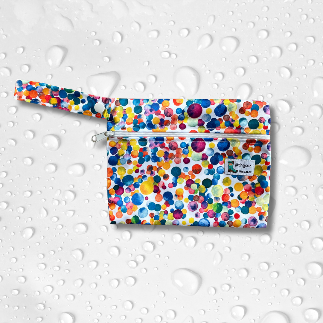 Small wetbag in a multicoloured dotty print.