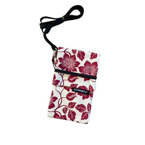 Cream phone pouch bag with red floral print and black lanyard.