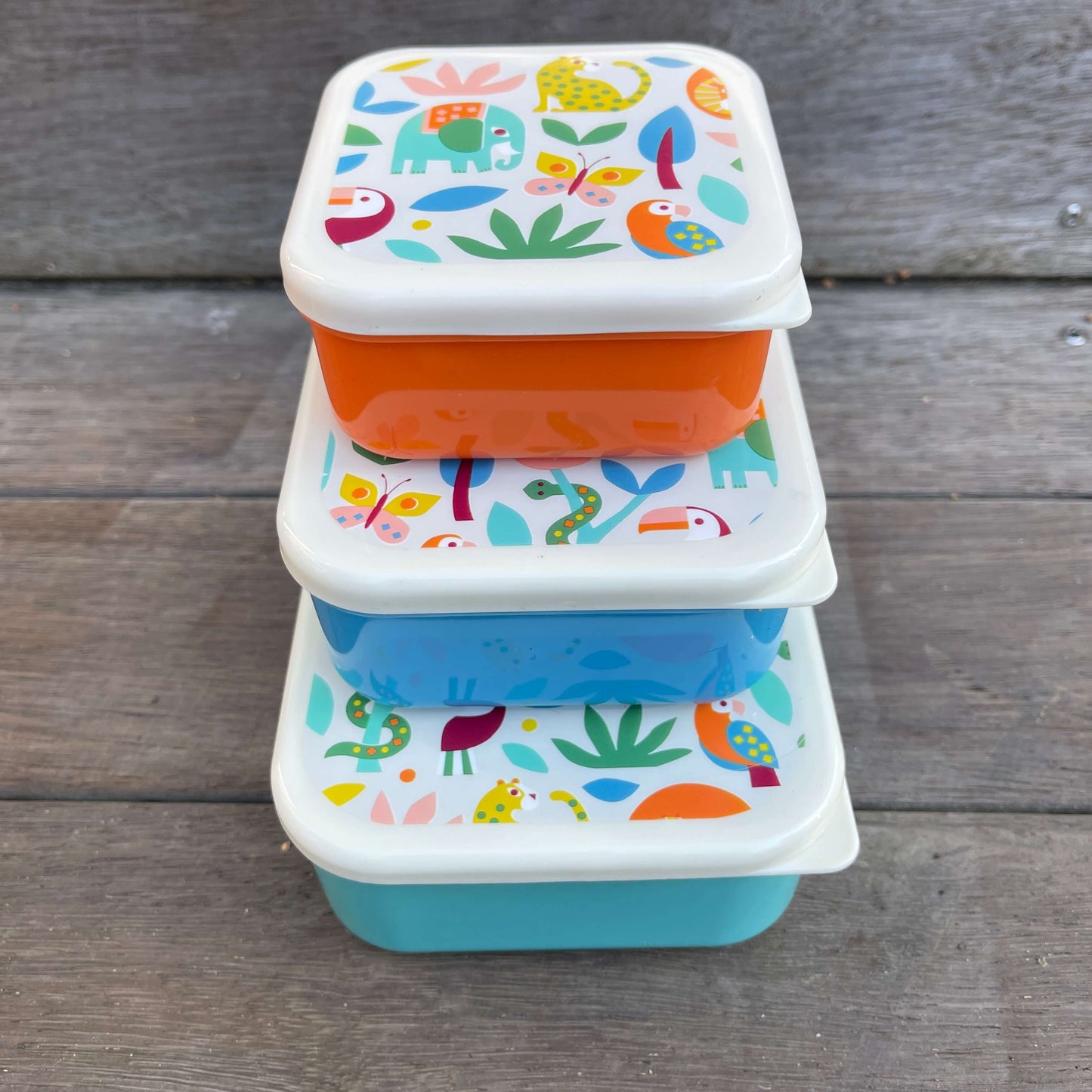 Trio of snack boxes in blue & orange featuring jungle animals on the lids.