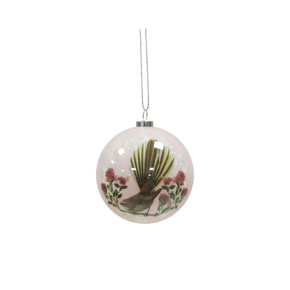 Pale pink Christmas bauble featuring a Fantail bird and Pohutukawa flowers.
