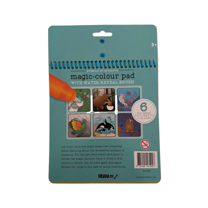 A children's magic colour pad with water-reveal brush, shown from the back on a light beige surface. The card is teal blue with product details, sample images of revealed and hidden pictures, and an illustration of an orange pencil.