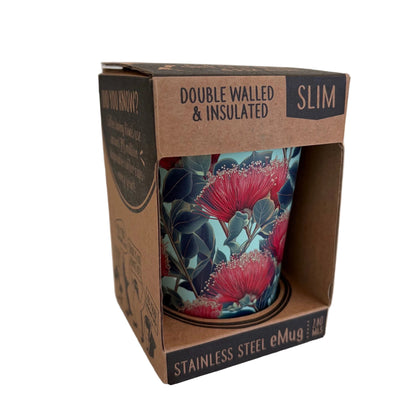 A stainless steel insulated eMug in its original brown cardboard packaging, featuring a floral design with red pohutukawa flowers on a dark teal background.