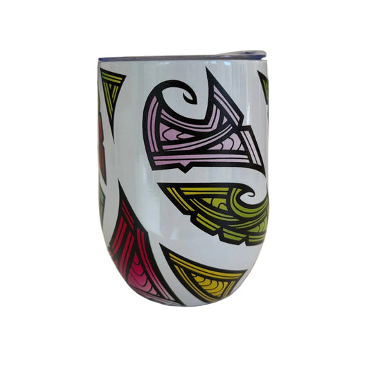 A white insulated tumbler with a colourful abstract Maori pattern in pink, yellow, and purple.