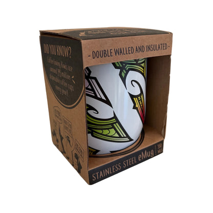 A stainless steel insulated coffee mug in its original brown cardboard packaging. The mug features a white base with a black, green, and red abstract Maori graphic design.