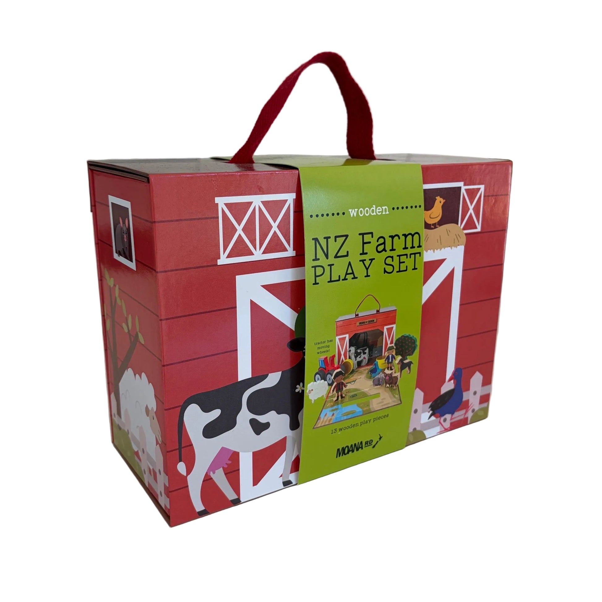 A red wooden toy box labeled 'NZ Farm PLAY SET' with a green front panel, shown on a white tabletop. The box features farm illustrations including a cow, barn, chicken, and tractor, plus a red carrying handle.