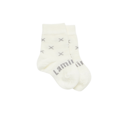 Baby crew socks in pretty cream knit merino wool with a grey X pattern.