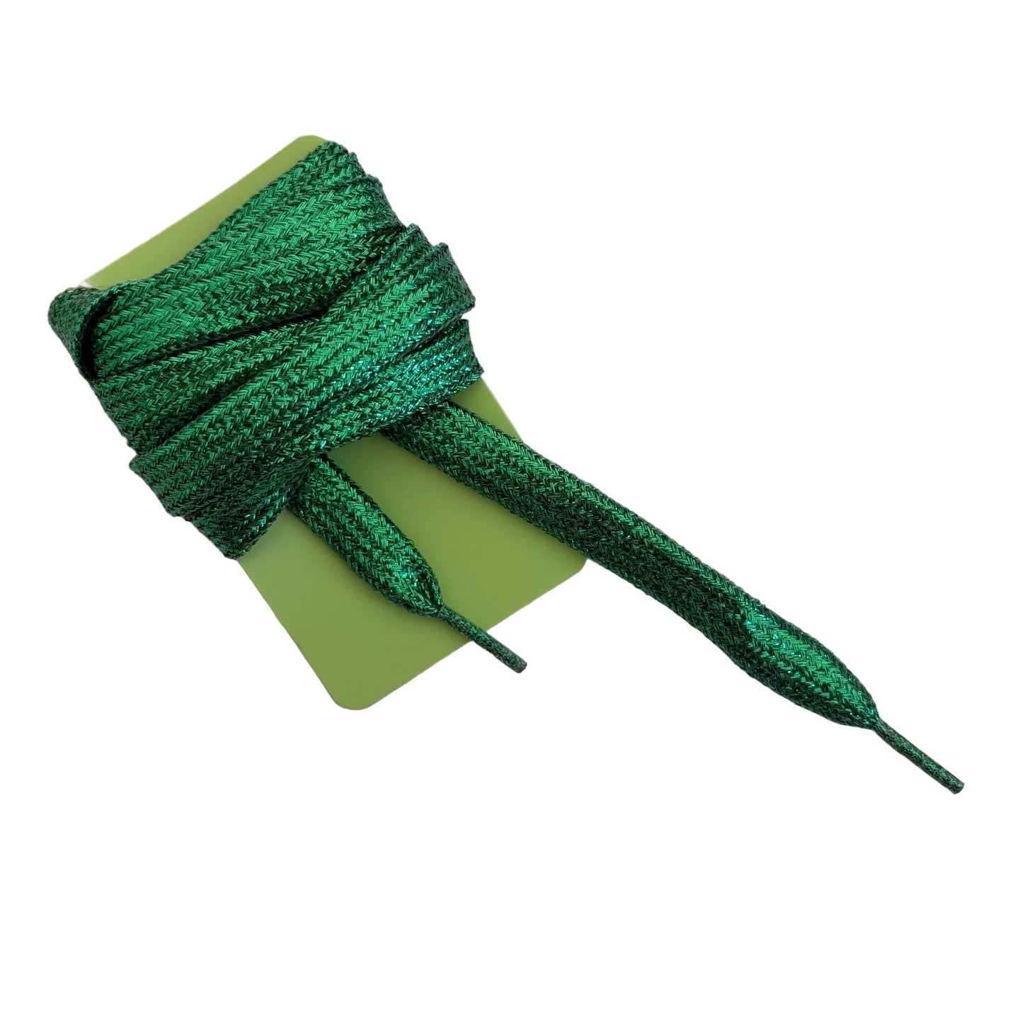 Green metallic shoelaces wrapped around a light green cardboard card, photographed on a plain light gray background.