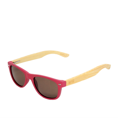 A pair of kids' sunglasses with a bright pink frame and natural bamboo wood temples, shown on a plain white background.