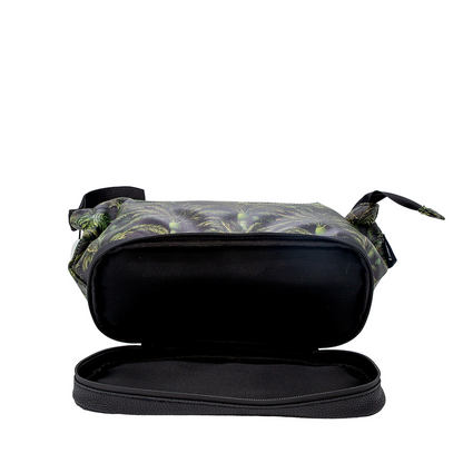 A zippered soft-sided case shown open on a plain white background, with a black interior and a dark exterior featuring a green leafy pattern.