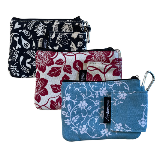 Trio of small purses in black, red and blue. Each with a floral print.