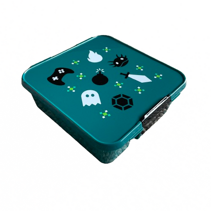 Teal green lunchbox with a black and white retro gamer print on the lid.