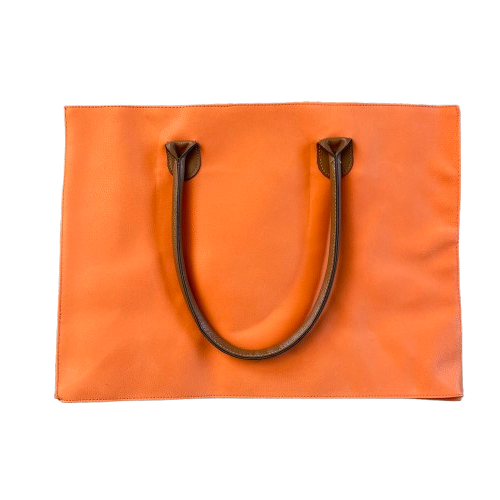 Bright orange tote bag in a faux suede with brown leather like handles.