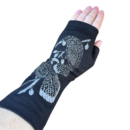 Fingerless merino gloves in black with grey Huia bird print.