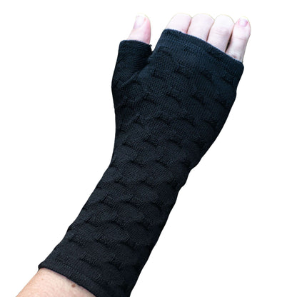Fingerless merino gloves in textured black knit.