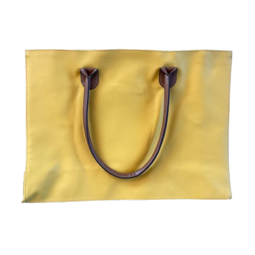 Bright yellow faux suede shopping tote bag with brown leather like handles.