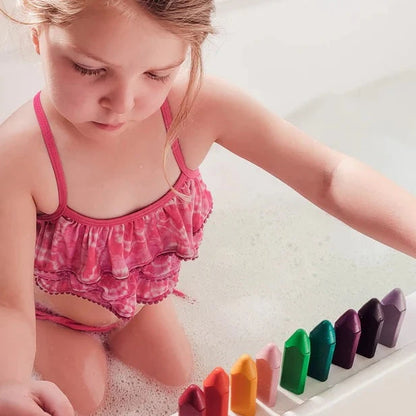 Child playing with bath crayons.