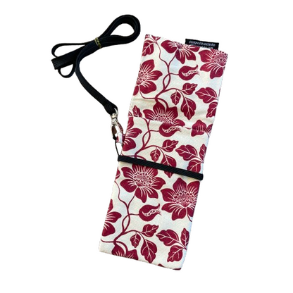 Cream phone pouch bag with red floral print and black lanyard. Pouch is opened up to show the pocket.