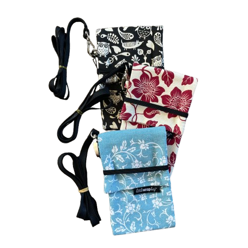 Set of three pouch bags in blue, red and black with floral prints.