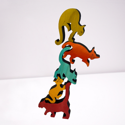 Wooden coloured balancing cats.