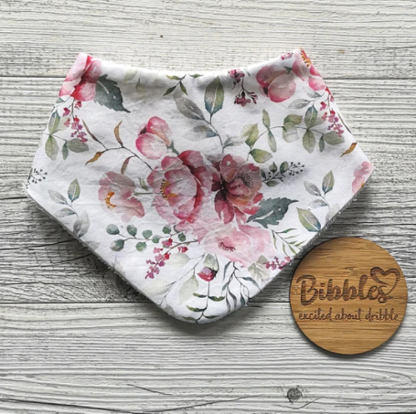 Pretty pink floral design bibs for babies made by Bibbles