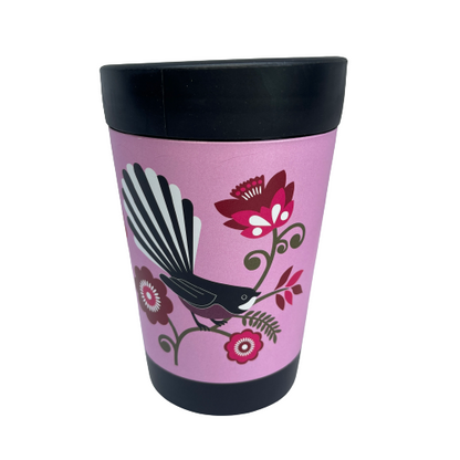 Black reusable coffee cup with bright pink wrap featuring a Fantail bird sitting on a green koru branch with pink flowers.