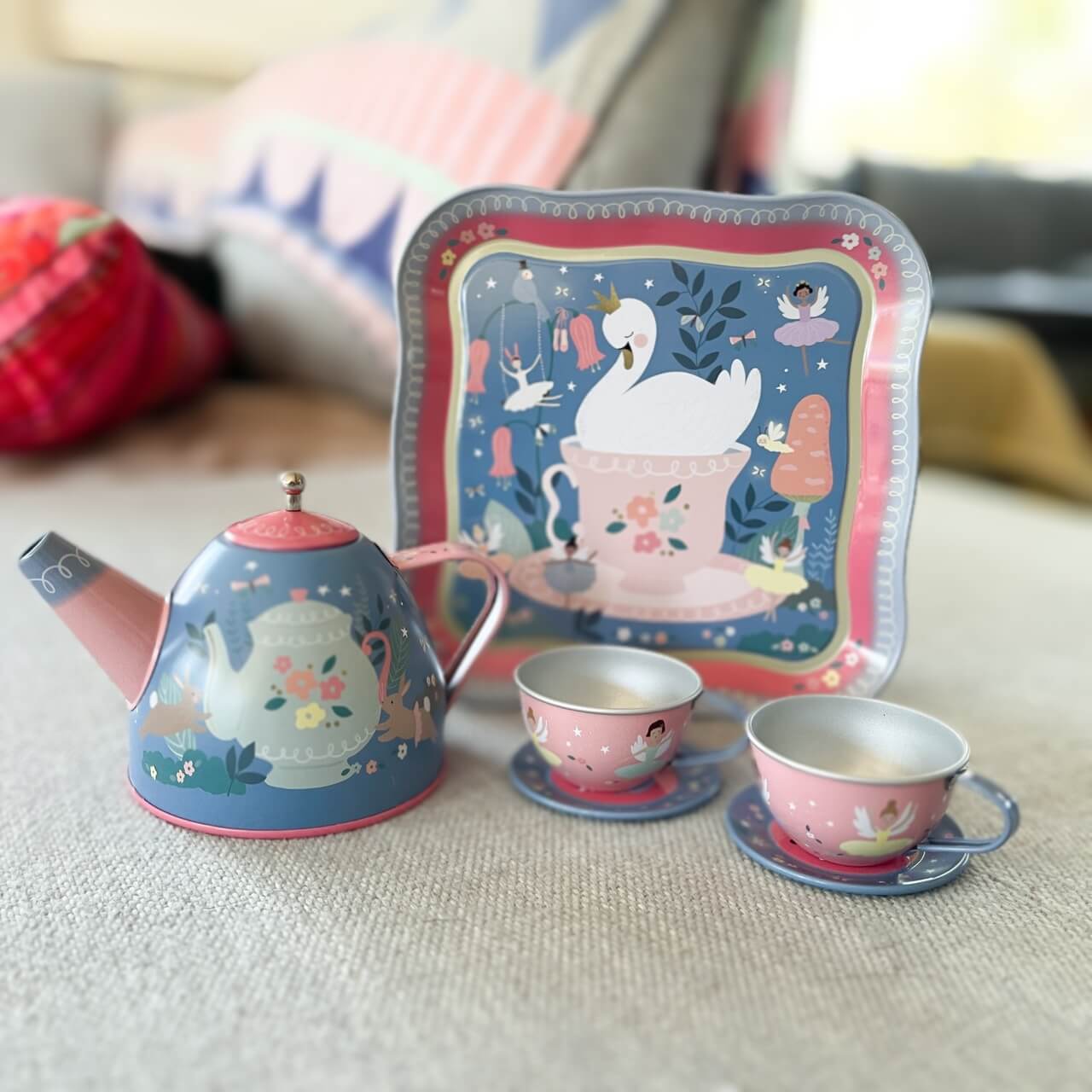 Childrens tin tea set with swan and fairy design.