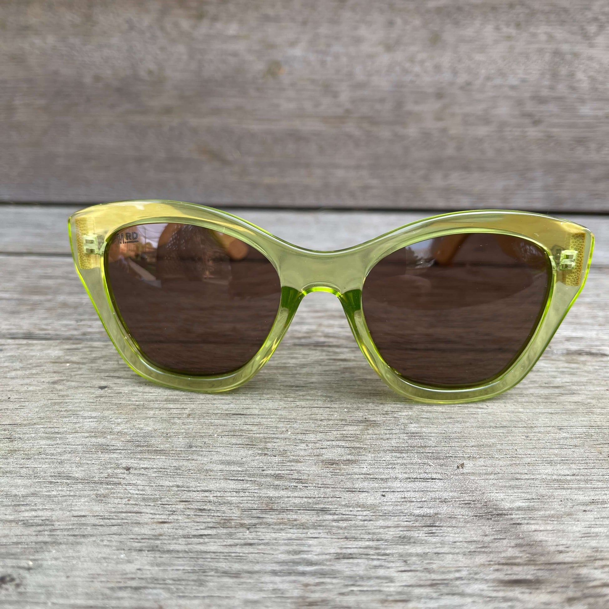 Womens sunglasses with light green frame and bamboo arms.