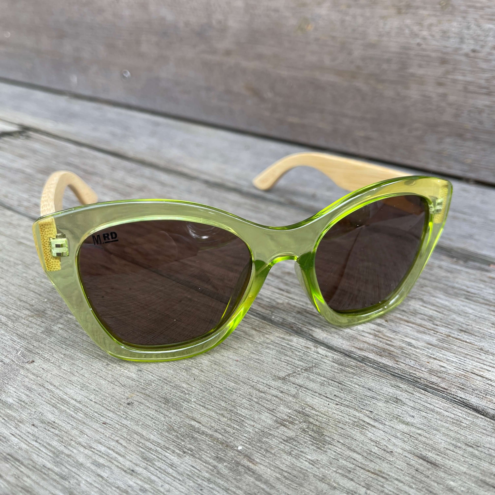 Womens sunglasses with light green frame and bamboo arms.