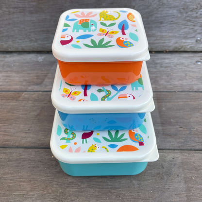 Trio of snack boxes in blue & orange  featuring jungle animals on the lids.