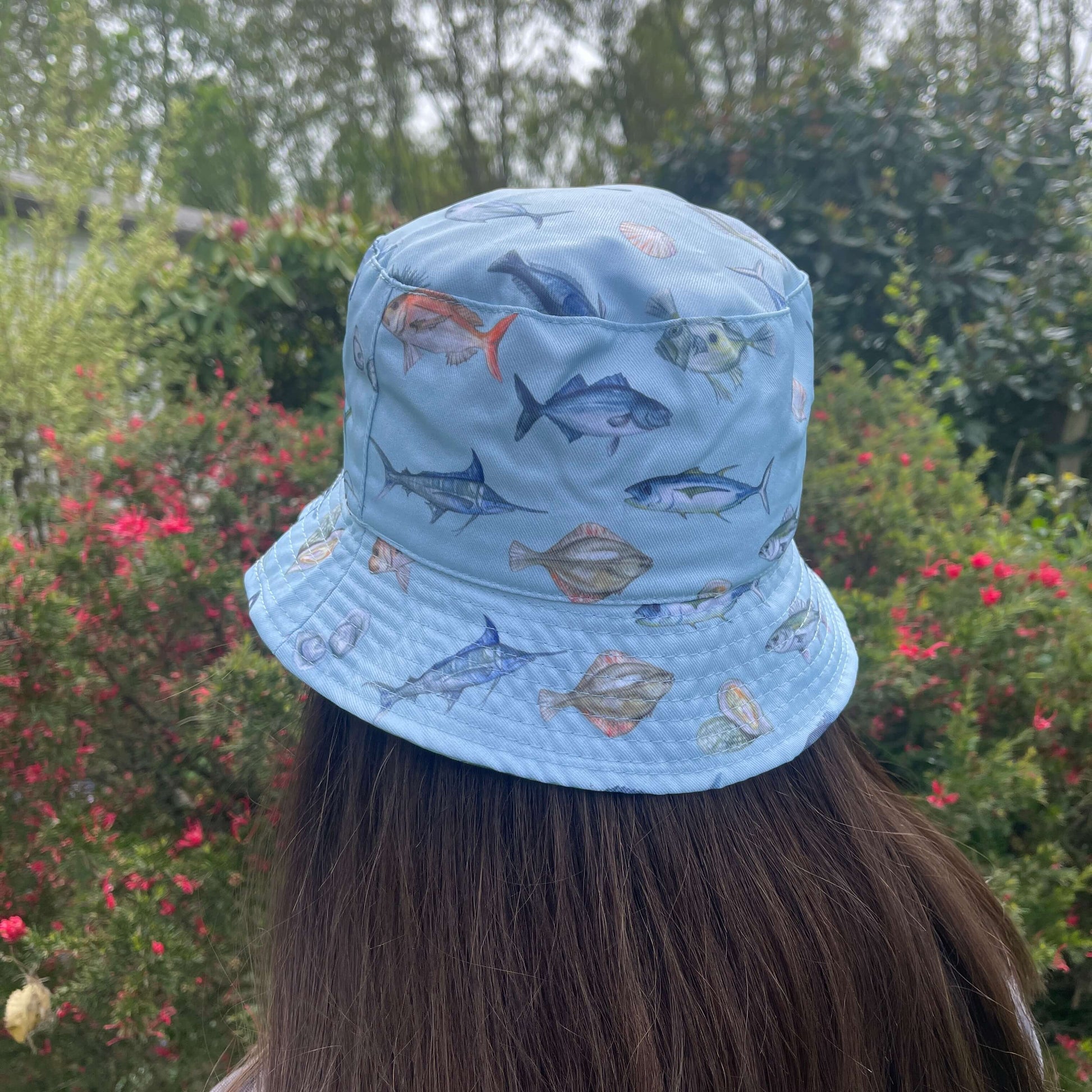 Bucket hat with NZ fish printed on it.
