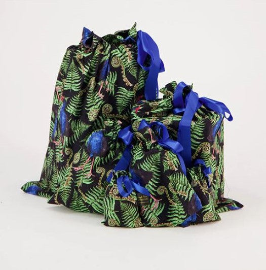 Reusable christmas gift bags with a fern and pukeko print and blue ribbon.