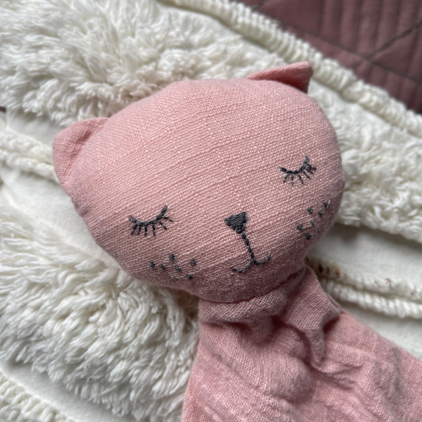 Rose coloured cat comforter.