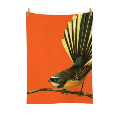 Bright orange Tea towel with a fantail on it.